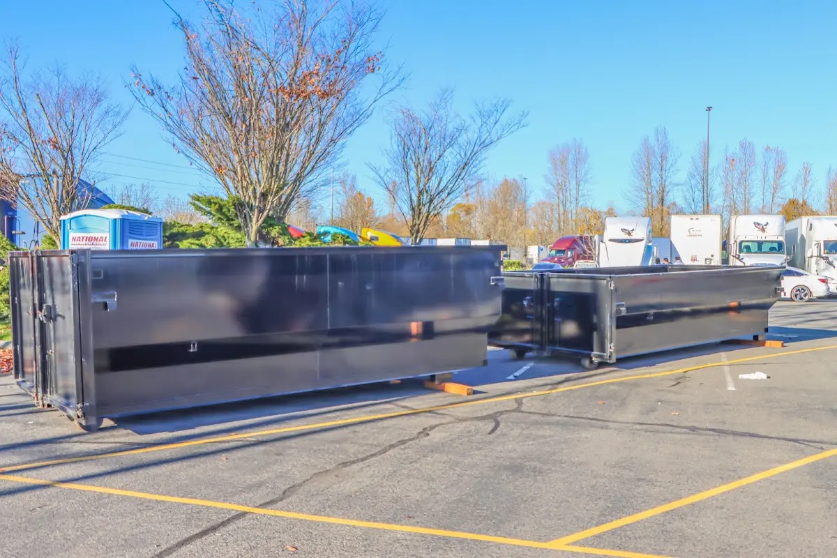 Professional dumpster rental service with roll-off container on residential driveway in Charlton